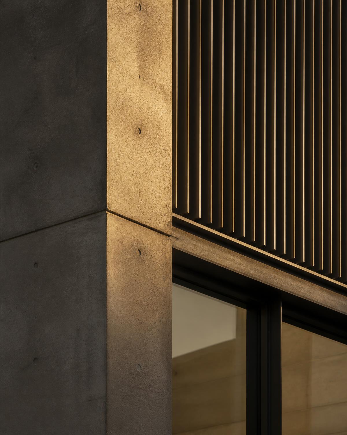 Architectural facade detail in concrete and warm stone